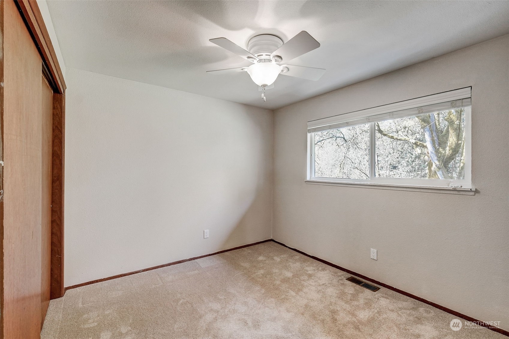 13227 Lake Kathleen Road Southeast Renton, WA 98059 - Photo 12 of 36 an empty room with windows and fan
