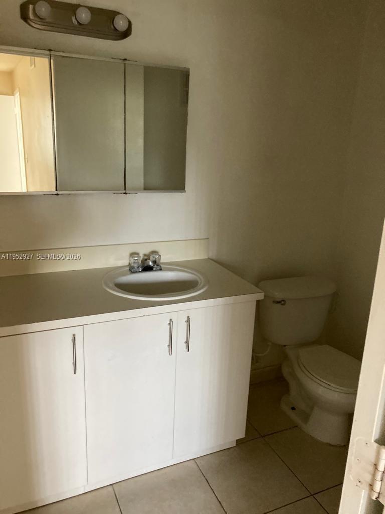 8705 Northwest 39th Street Sunrise, FL 33351 - Photo 11 of 13 a bathroom with a sink and a toilet