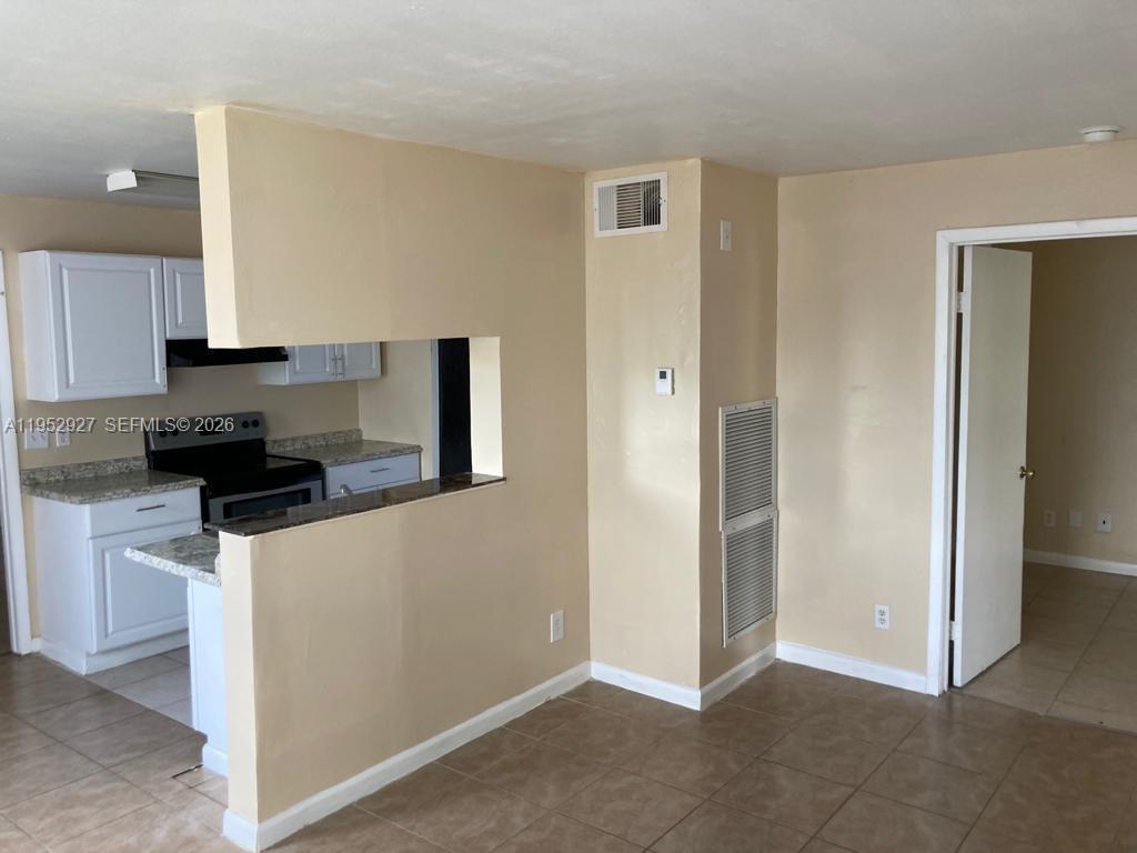 8705 Northwest 39th Street Sunrise, FL 33351 - Photo 2 of 13 a kitchen with stainless steel appliances granite countertop a refrigerator and a stove