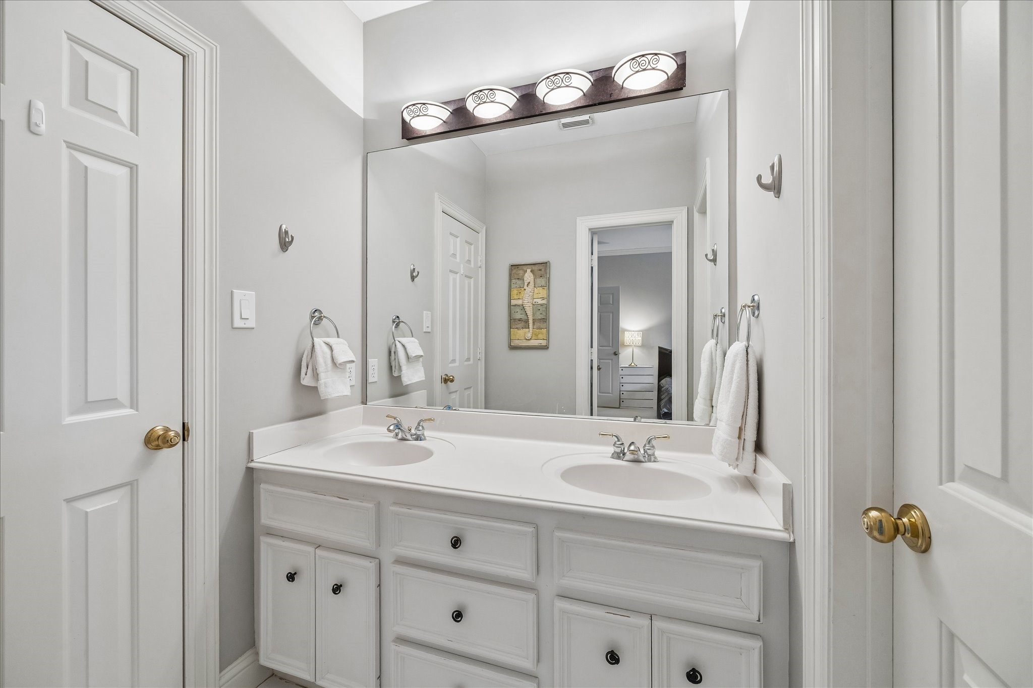 11421 Whippoorwill Road Houston, TX 77024 - Photo 22 of 33 a bathroom with a double vanity sink and a mirror