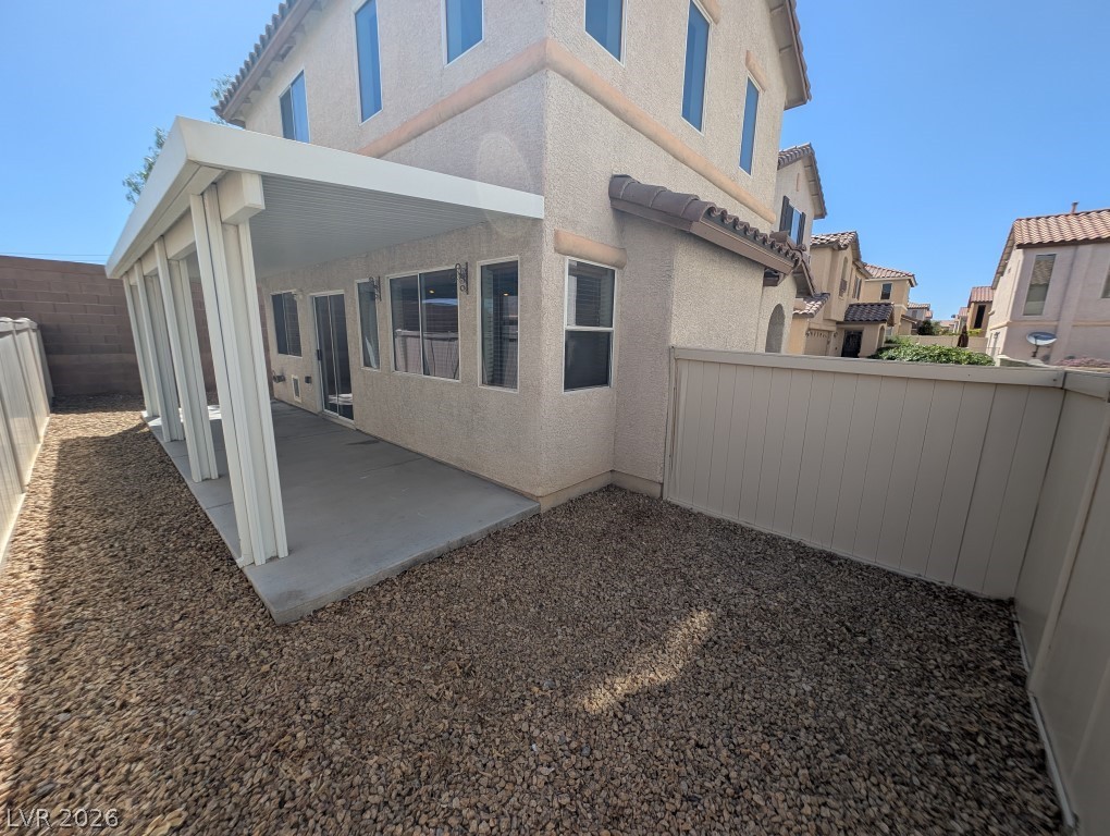 9121 Spoonbill Ridge Place Las Vegas, NV 89143 - Photo 22 of 26 A spacious covered patio provides a delightful outdoor retreat in this private backyard.
