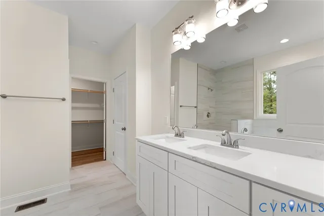 a bathroom with a double vanity sink and a mirror