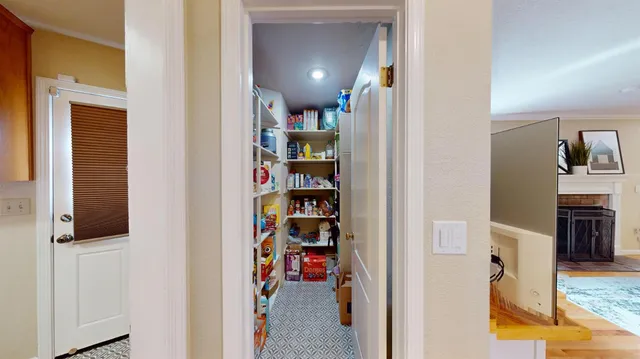 a view of a hallway with seating area