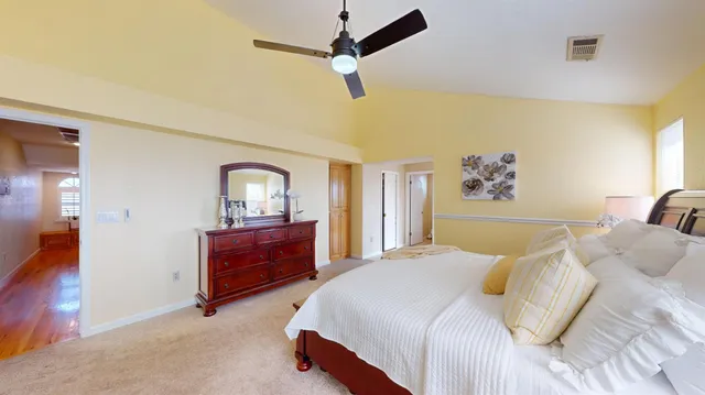 a bedroom with a bed and a painting on the wall