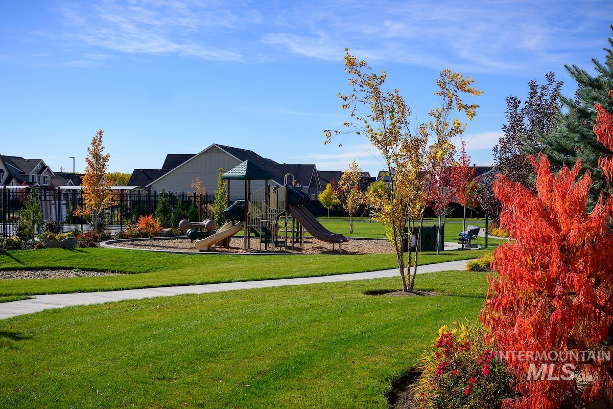 1735 East Acme Street Meridian, ID 83642 - Photo 5 of 8 Community park featuring a multi-level play structure with slides, open green space, paved pathways, mature trees, and landscaped planting beds