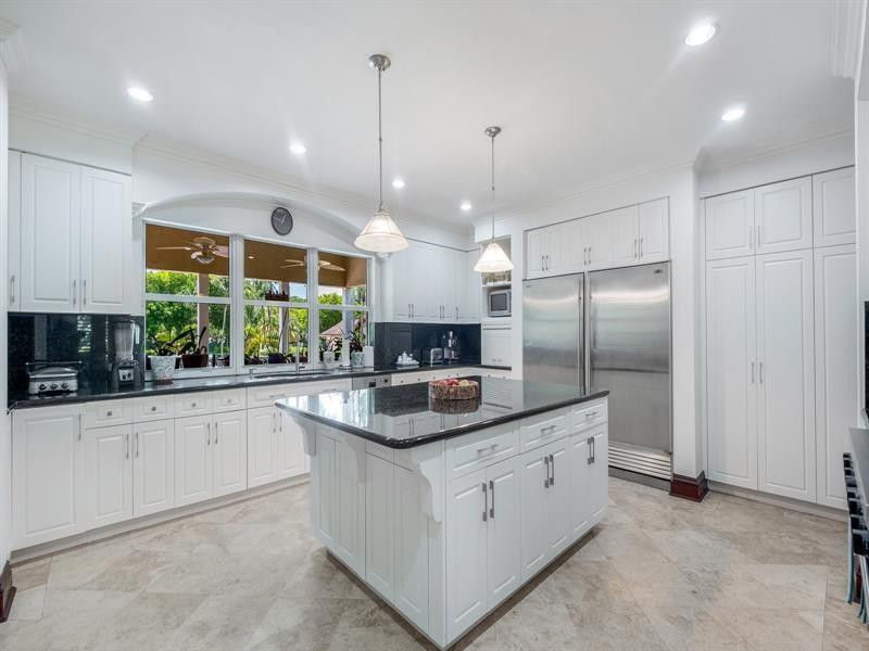 441 Ridge Road Coral Gables, FL 33143 - Photo 12 of 23 a kitchen with stainless steel appliances granite countertop a sink a stove and a refrigerator