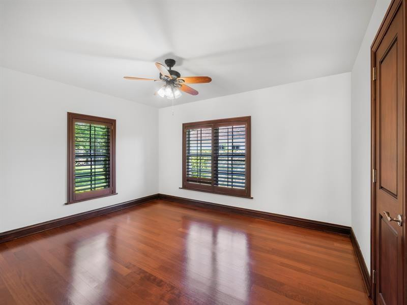 441 Ridge Road Coral Gables, FL 33143 - Photo 16 of 23 a view of an empty room with a window and wooden floor
