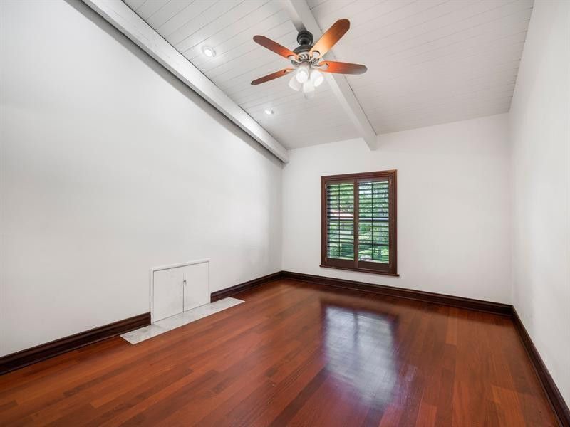 441 Ridge Road Coral Gables, FL 33143 - Photo 17 of 23 an empty room with wooden floor and windows