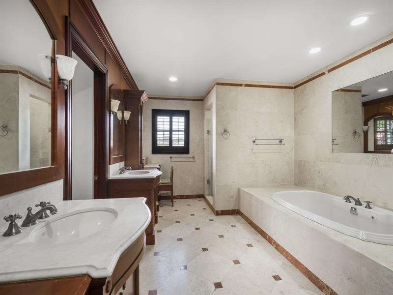 441 Ridge Road Coral Gables, FL 33143 - Photo 23 of 23 a spacious bathroom with a tub sink and mirror