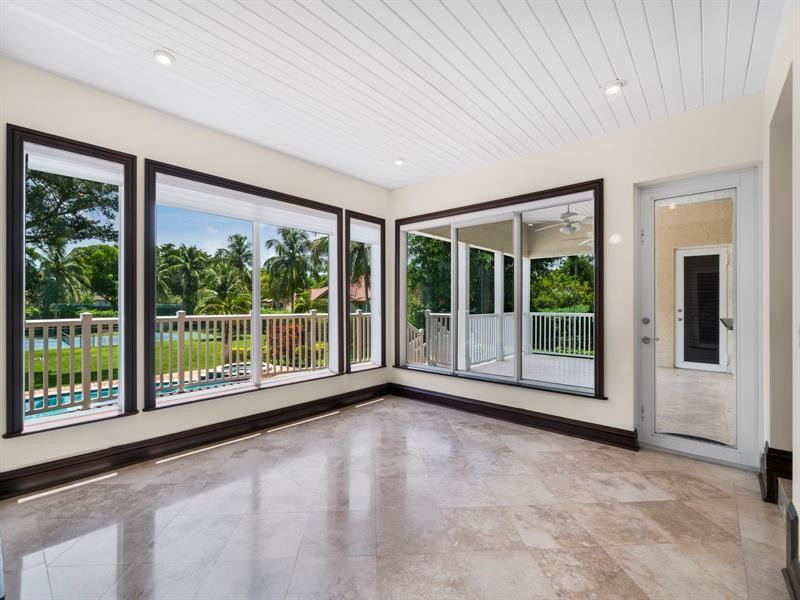441 Ridge Road Coral Gables, FL 33143 - Photo 9 of 23 a view of an empty room with wooden floor and a balcony