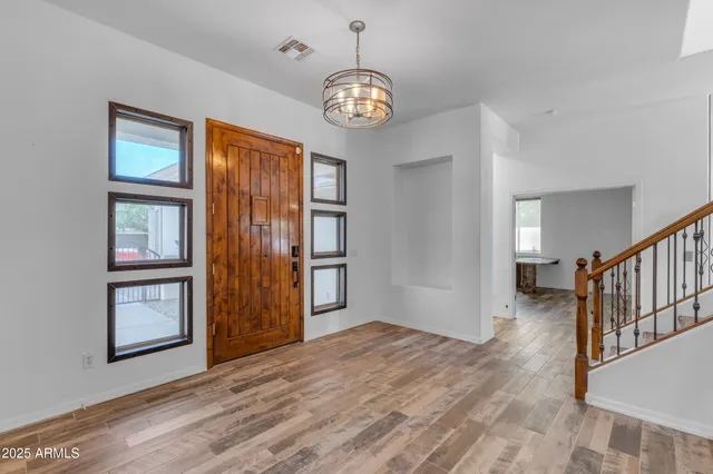 a view of a dining room and livingroom with furniture wooden floor