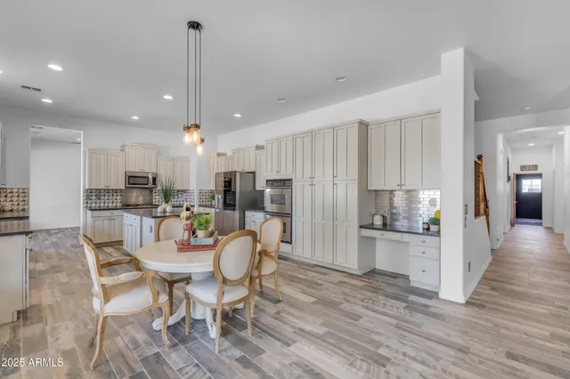 a kitchen with granite countertop a refrigerator and a sink