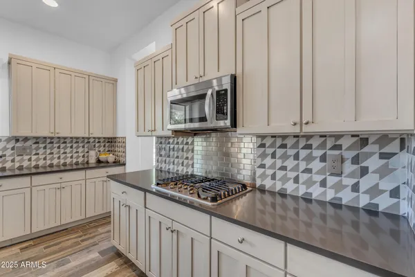 a bathroom with a sink double vanity granite tub and a mirror