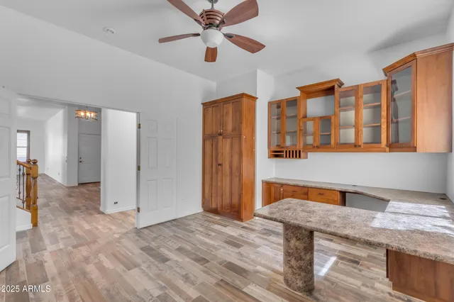 a bathroom with a granite countertop sink a toilet and shower