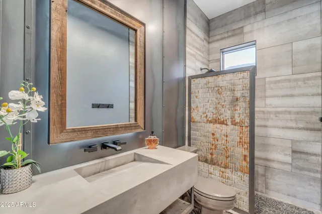 a bathroom with a tub sink and mirror