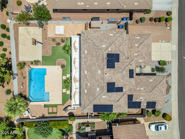 a view of a house with swimming pool and sitting area
