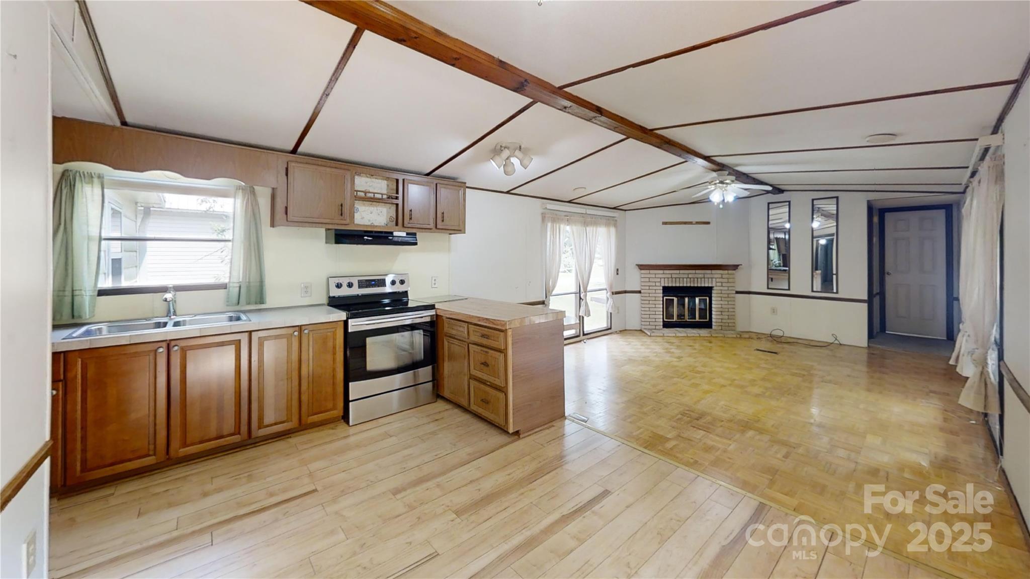 8112 Blackwood Road Denver, NC 28037 - Photo 12 of 19 a kitchen with granite countertop a refrigerator and wooden floor
