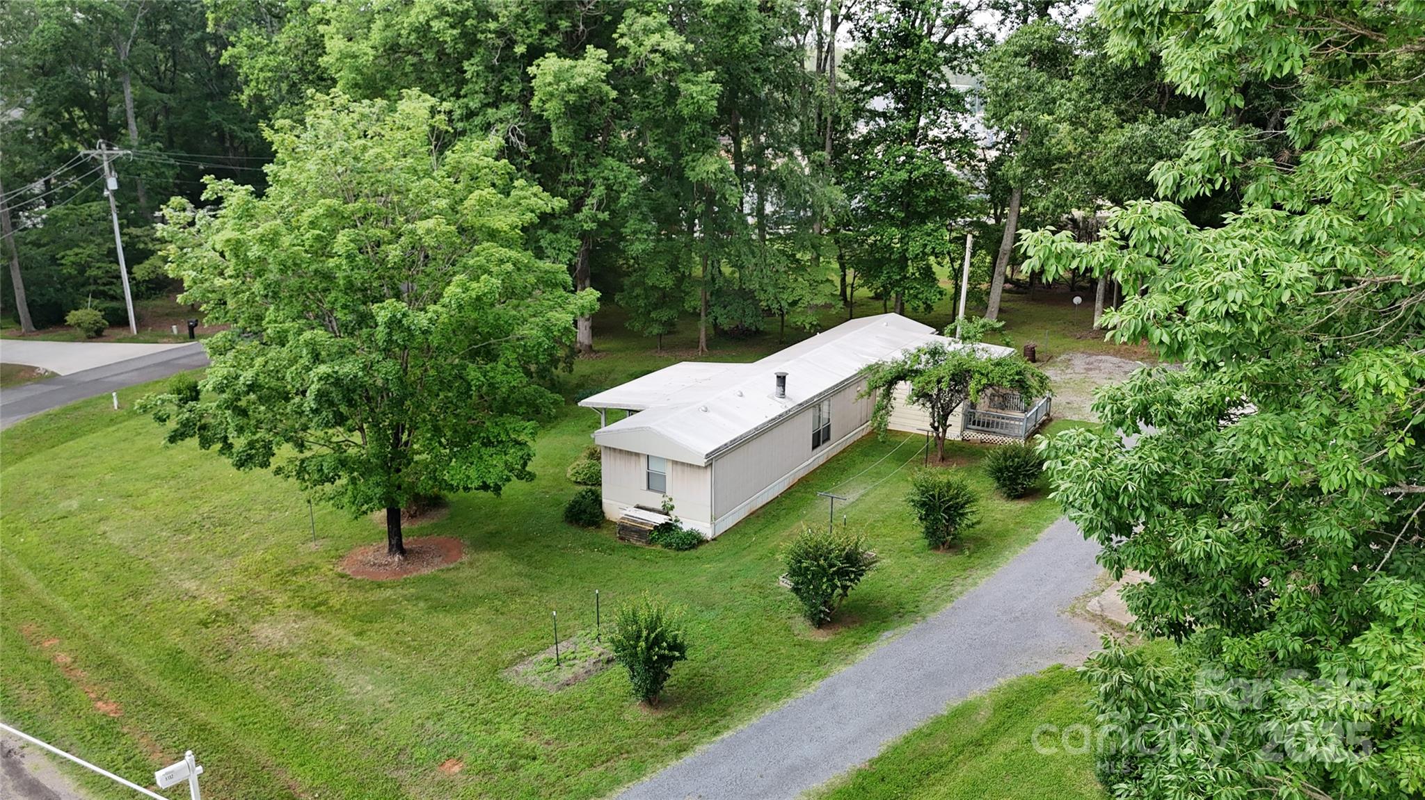 8112 Blackwood Road Denver, NC 28037 - Photo 4 of 19 a view of a house with a yard and large trees