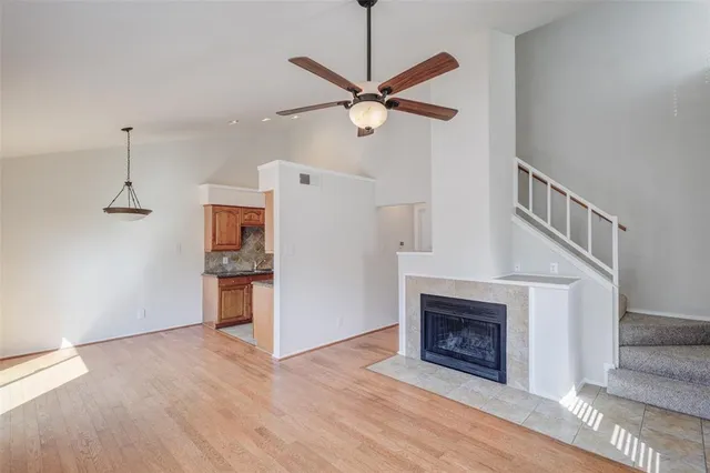 a view of a livingroom with a fireplace and a ceiling fan