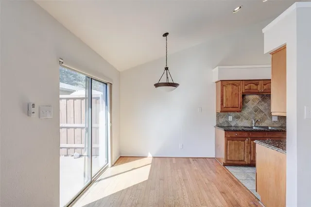 a view of a room with a sink and mirror