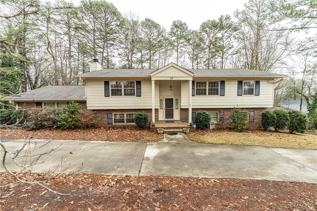 33 Saddle Mountain Road Southeast Rome, GA 30161 - Photo 1 of 1 a front view of a house with a yard and a garage