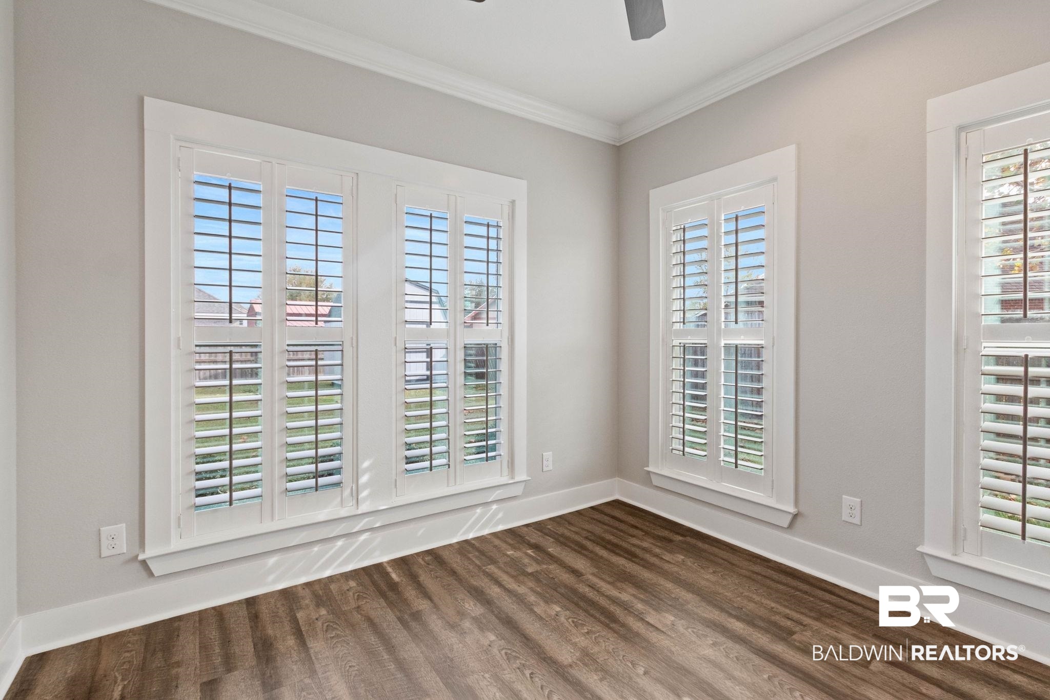 17376 Bankhead Boulevard Fairhope, AL 36532 - Photo 33 of 73 Unfurnished room with ornamental molding, dark wood-style floors, and a ceiling fan