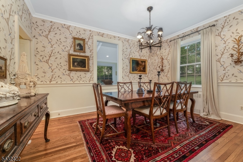 11 New Street Mendham, NJ 07945 - Photo 6 of 35 a view of a dining room with furniture a chandelier and wooden floor