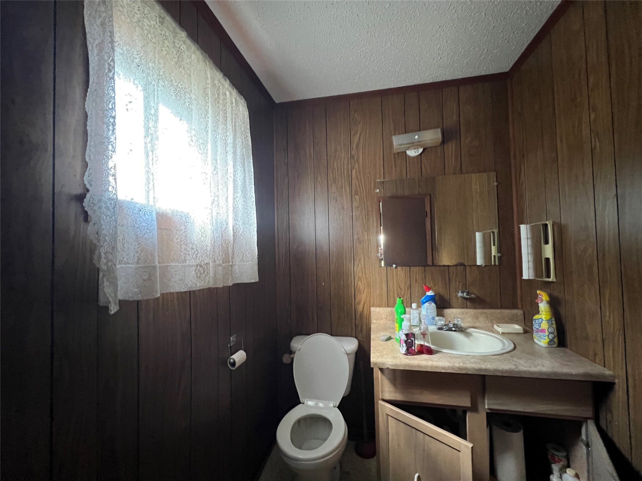 Tbd Filmore Street Trinity, TX 75862 - Photo 23 of 26 a bathroom with a granite countertop sink vanity mirror and toilet