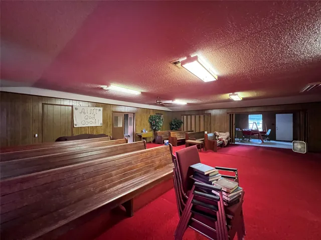 a view of a dining room with furniture a chandelier and wooden floor