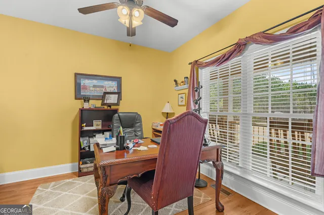 a spacious bathroom with a sink a mirror a bathtub and next to a window
