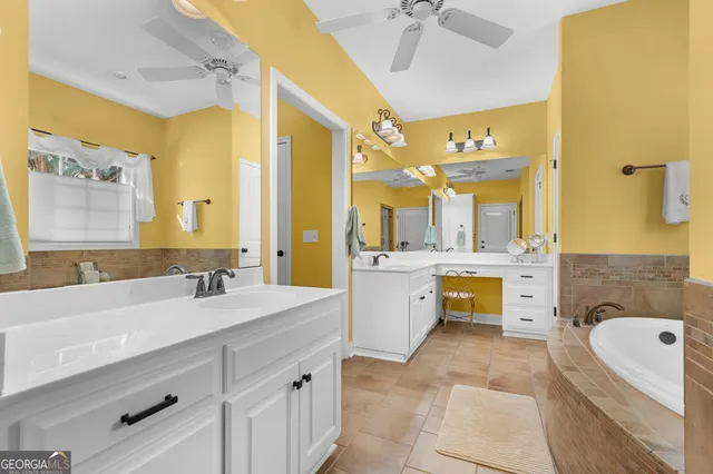 a bathroom with a tub a sink and a shower