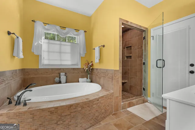 a spacious bedroom with a bed and a chandelier