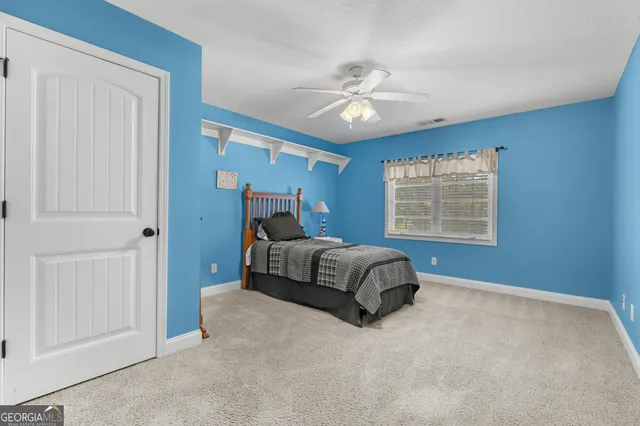 a spacious bedroom with a bed and a chandelier