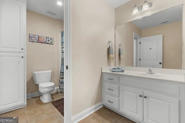 a white toilet sitting next to a bath tub