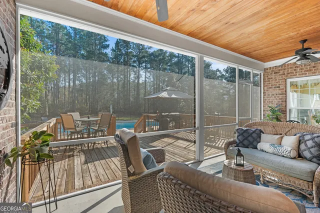 a view of a house with swimming pool and sitting area