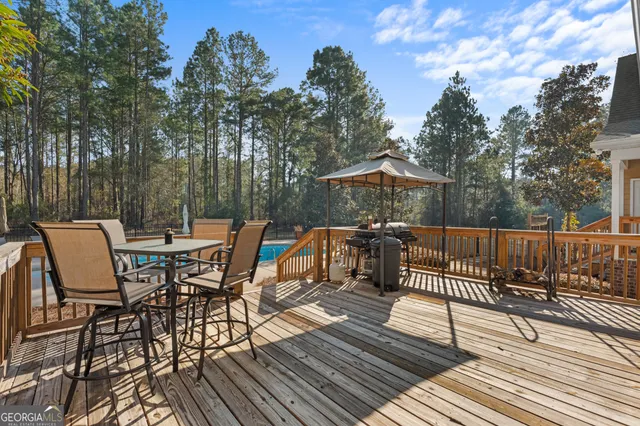 a view of a house with a big yard and large trees