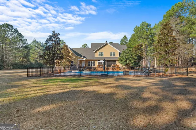 an aerial view of a wooden chairs and fire pit