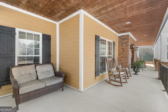 a view of hallway with wooden floor and stairs