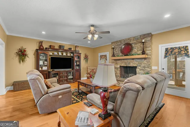 a living room with furniture a flat screen tv and a fireplace