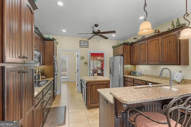 a kitchen with stainless steel appliances a sink stove and refrigerator