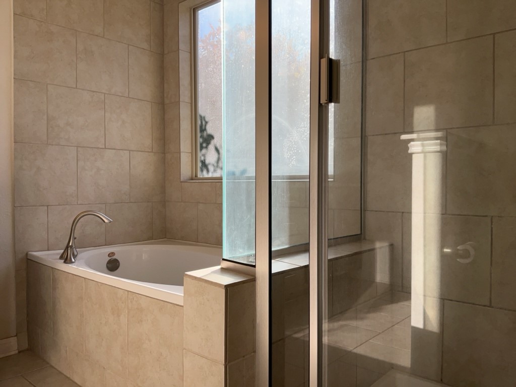 2909 Tempe Drive Leander, TX 78641 - Photo 23 of 38 Primary bathroom with soaking tub and walk-in shower