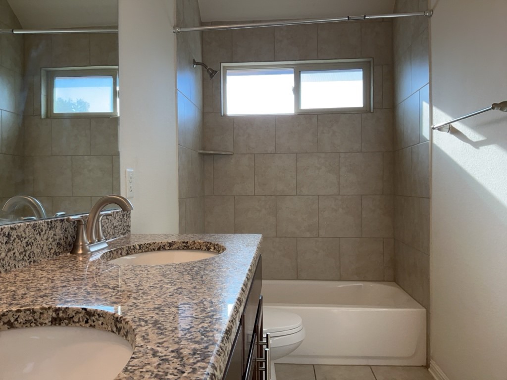 2909 Tempe Drive Leander, TX 78641 - Photo 27 of 38 Full bathroom with dual sinks and shower/tub combination