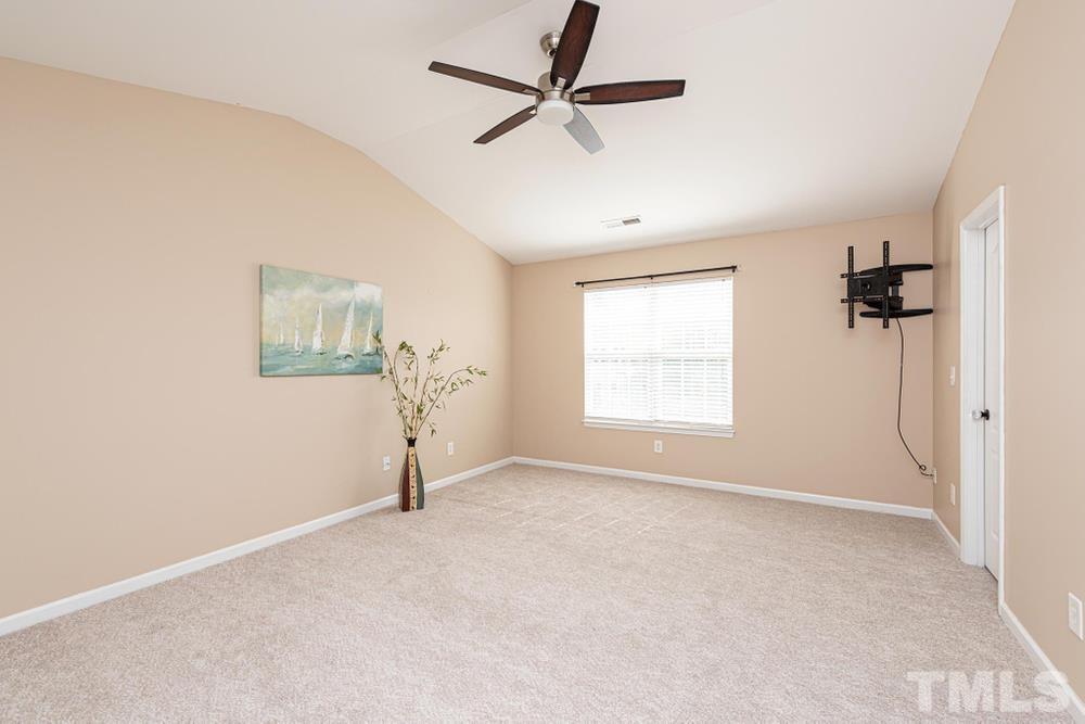 3519 Oneonta Avenue Raleigh, NC 27604 - Photo 13 of 30 Primary Bedroom with cathedral ceiling and ceiling fan.