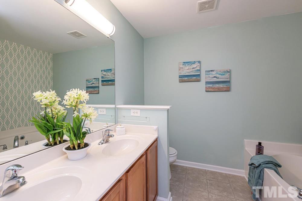 3519 Oneonta Avenue Raleigh, NC 27604 - Photo 16 of 30 Primary Bathroom with dual vanity sink and privacy wall to toilet.