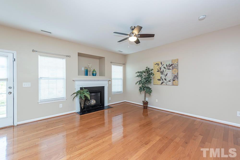 3519 Oneonta Avenue Raleigh, NC 27604 - Photo 6 of 30 Hardwoods in Living Room along with ceiling fan and TV niche above fireplace.