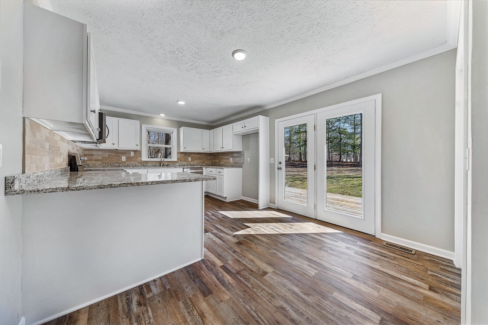 118 Rollins Road Sparta, TN 38583 - Photo 12 of 33 a kitchen with stainless steel appliances granite countertop a stove top oven a sink and a refrigerator
