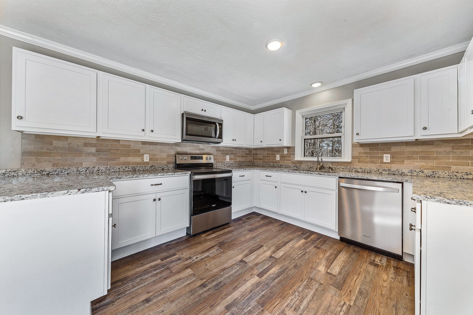 118 Rollins Road Sparta, TN 38583 - Photo 13 of 33 a kitchen with granite countertop white cabinets and white appliances