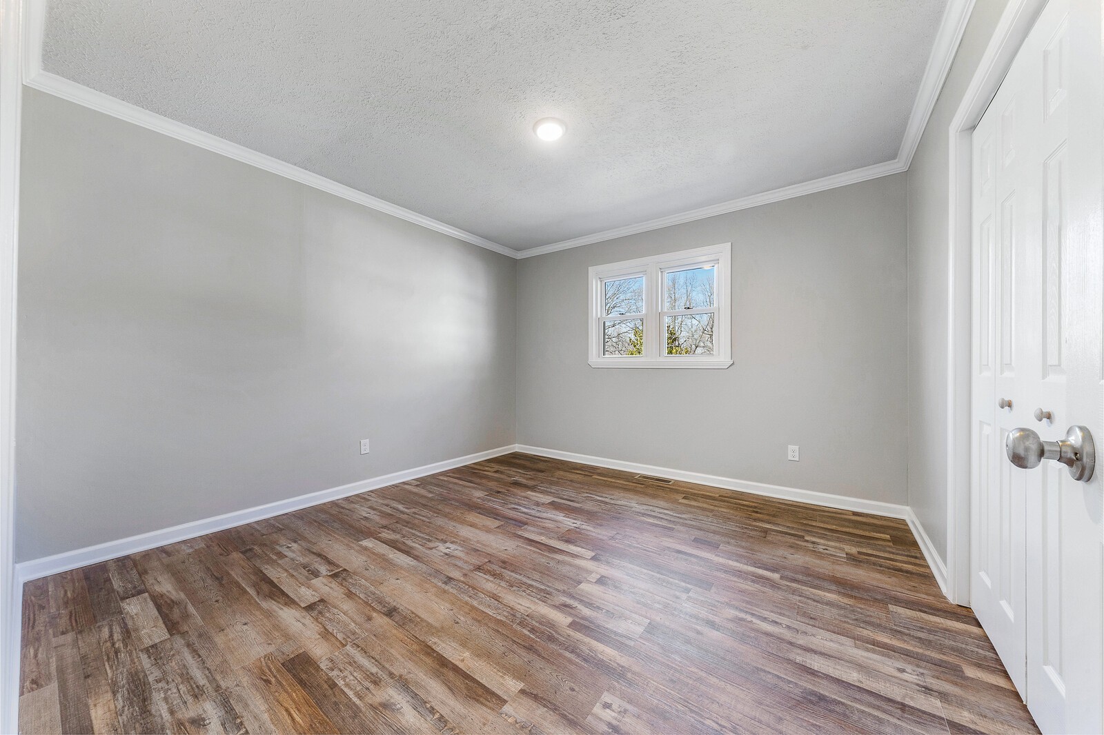 118 Rollins Road Sparta, TN 38583 - Photo 21 of 33 an empty room with wooden floor and windows