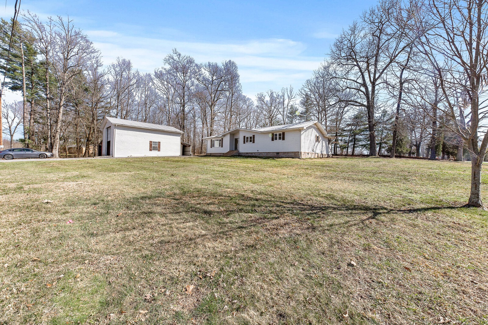 118 Rollins Road Sparta, TN 38583 - Photo 3 of 33 a big house with trees in front of it