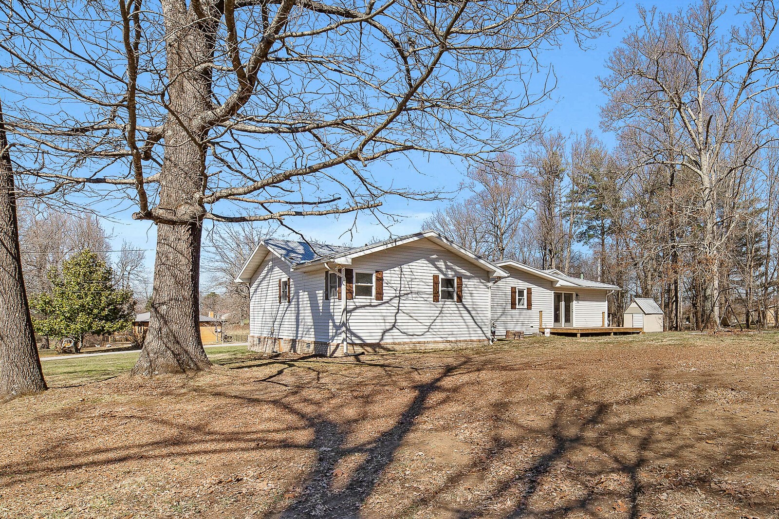 118 Rollins Road Sparta, TN 38583 - Photo 4 of 33 a white house that has a tree in front of it